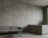 Nowoczesny salon z betonem architektonicznym. Sofa, stolik kawowy i recepcja tworzą minimalistyczną aranżację wnętrz.